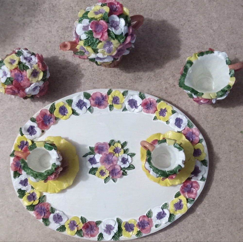 10 Piece Mini tea set made of polyresin. It's NIB and flowers is the theme